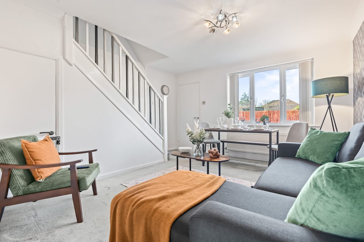 Open-plan living and dining room with staircase in Coventry house