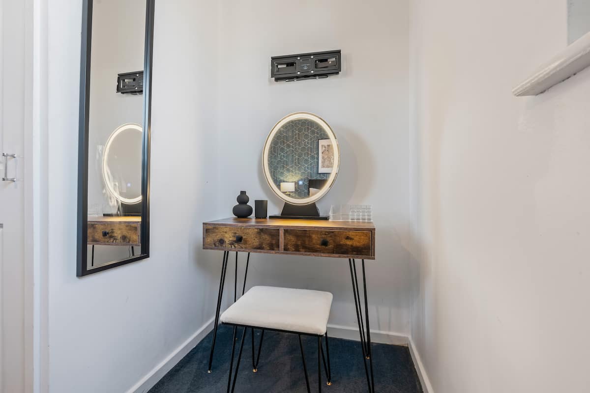 Dressing area with vanity and mirror in Coventry house