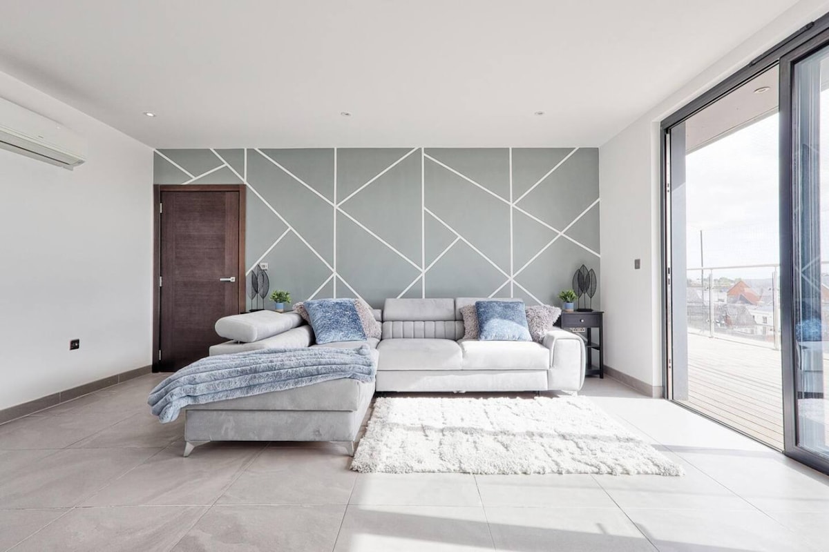 Spacious living room with floor-to-ceiling sliding doors onto private terrace