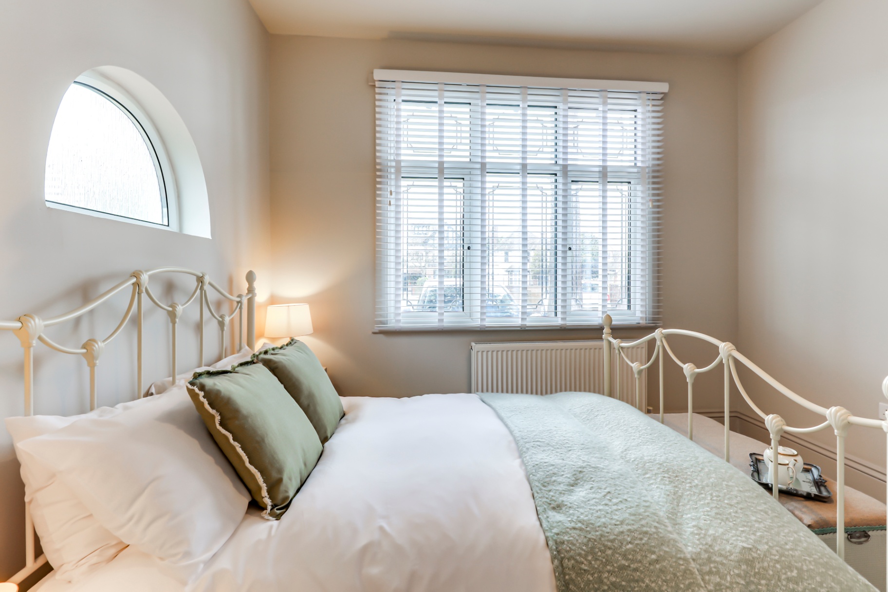 Double bedroom with arched window in Southend-on-Sea bungalow