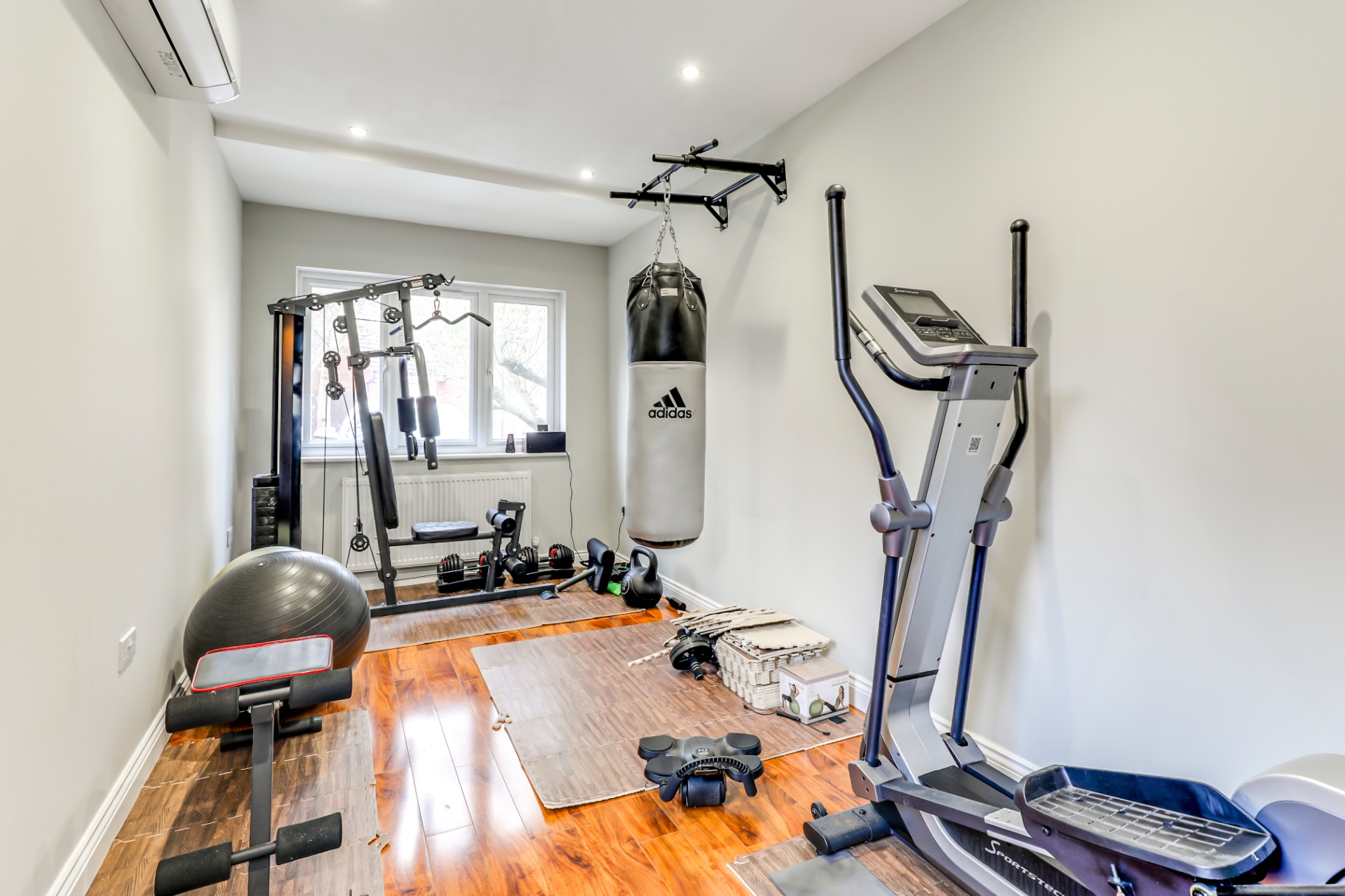 Private gym with cardio and weights in Wickford house